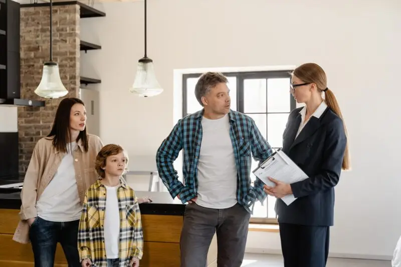 Group of people in an indoor setting with a real estate agent