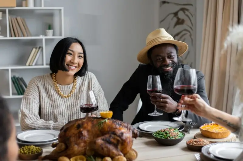 People dining at a table with wine and food