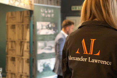 Person wearing jacket with Alexander Lawrence logo