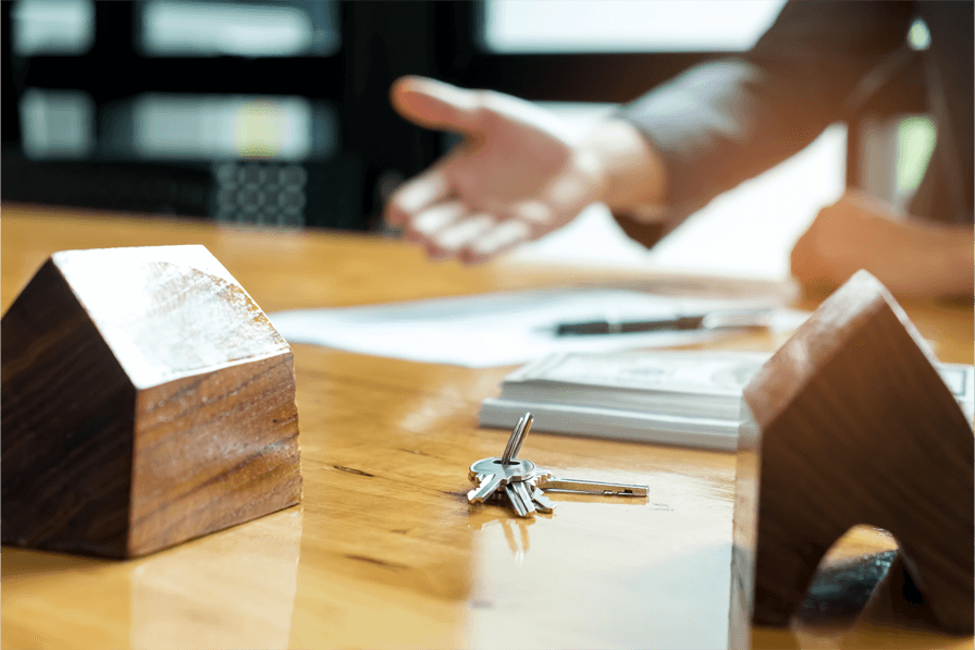 Real estate meeting with keys on a table